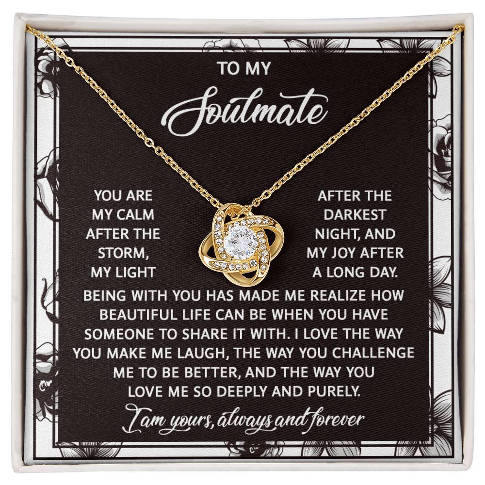 The Soulmate-Deeply And Purely - Love Knot Necklace showcases a cubic zirconia entwined design centered around a sparkling stone. Presented on a black card, it features a heartfelt message for a soulmate, symbolizing an unbreakable bond.