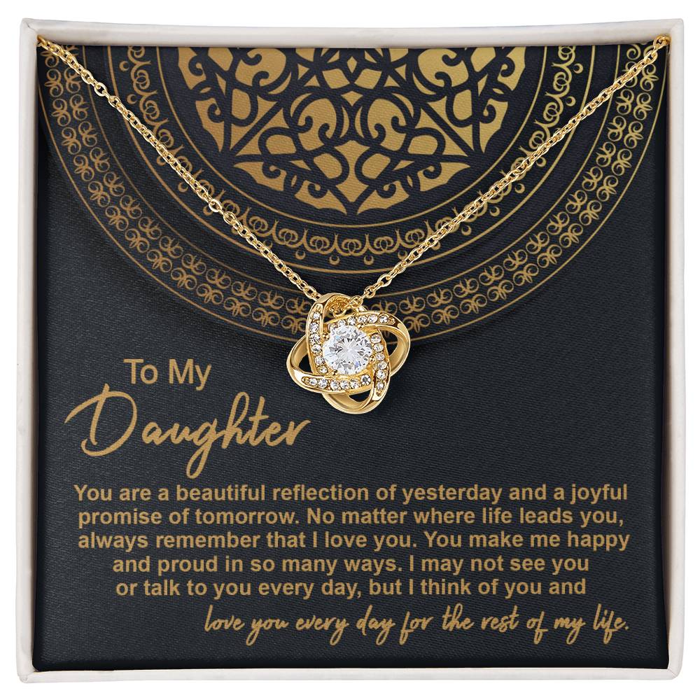 The "To Daughter, Beautiful Reflection 2 - Love Knot Necklace" in 14k white gold is elegantly presented in a black gift box adorned with gold patterns. The box carries the inscription "To My Daughter" along with a heartfelt message expressing love and pride.