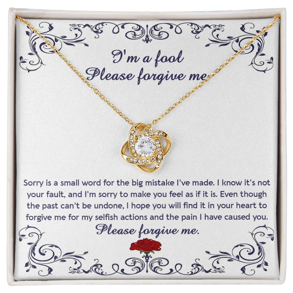 The "Sorry, I_m A Fool - Love Knot Necklace" features a 14k white gold pendant encased in a box with a heartfelt apology message. This message conveys regret and seeks forgiveness for causing pain and acting selfishly. The pendant is adorned with premium cubic zirconia crystals, adding an extra touch of elegance.