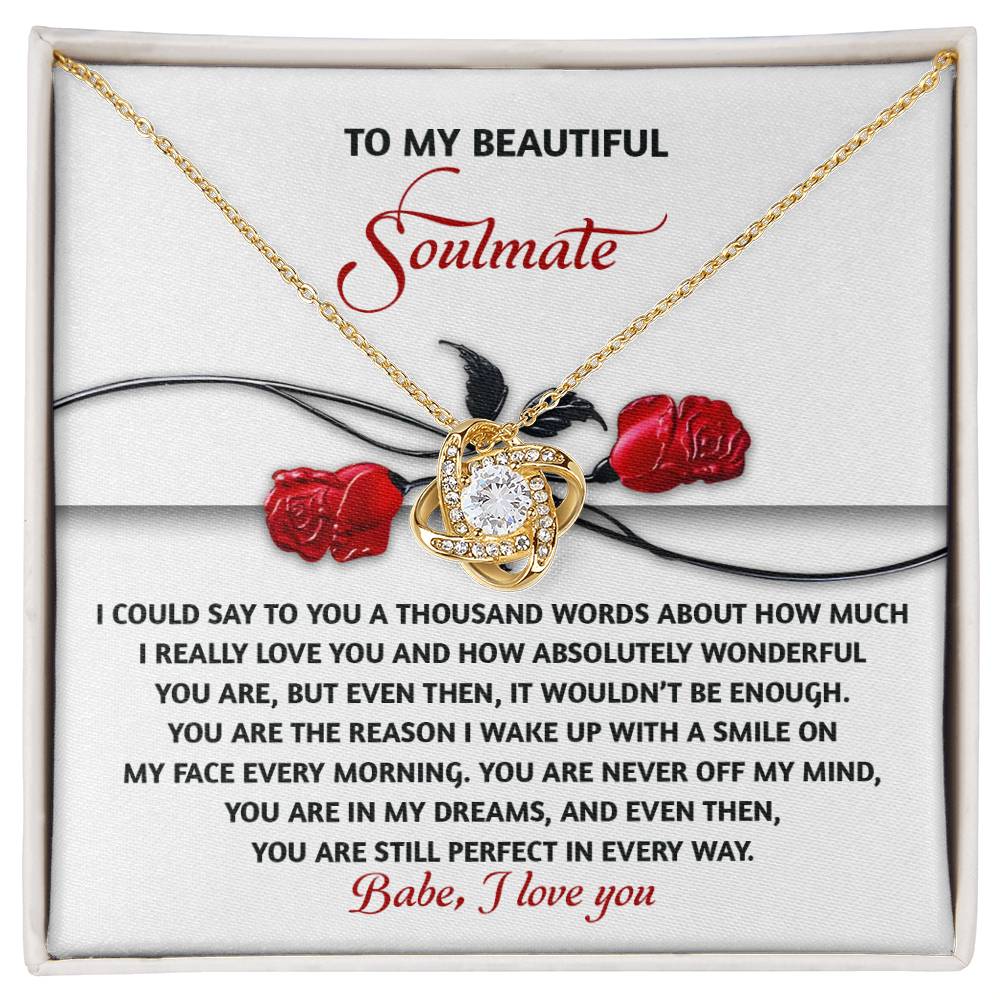 The Soulmate-Every Morning - Love Knot Necklace, featuring cubic zirconia crystals, is beautifully displayed above a card with red roses and a touching message to "Soulmate," symbolizing your unbreakable bond.