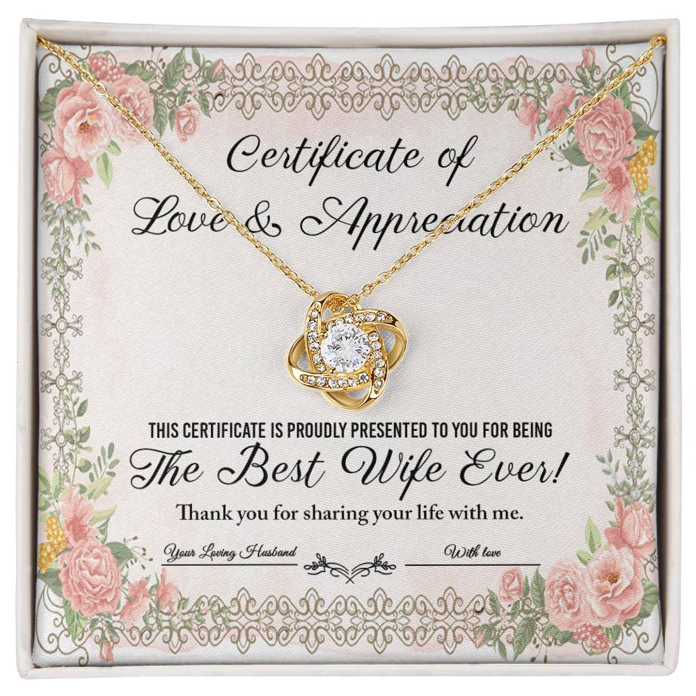 The "To Wife, Love & Appreciation - Love Knot Necklace" features a heart-shaped pendant elegantly displayed over a "Certificate of Love & Appreciation," expressing gratitude for being "The Best Wife Ever!" The necklace showcases a gold finish with sparkling cubic zirconia crystals, and the certificate is beautifully adorned with floral borders.