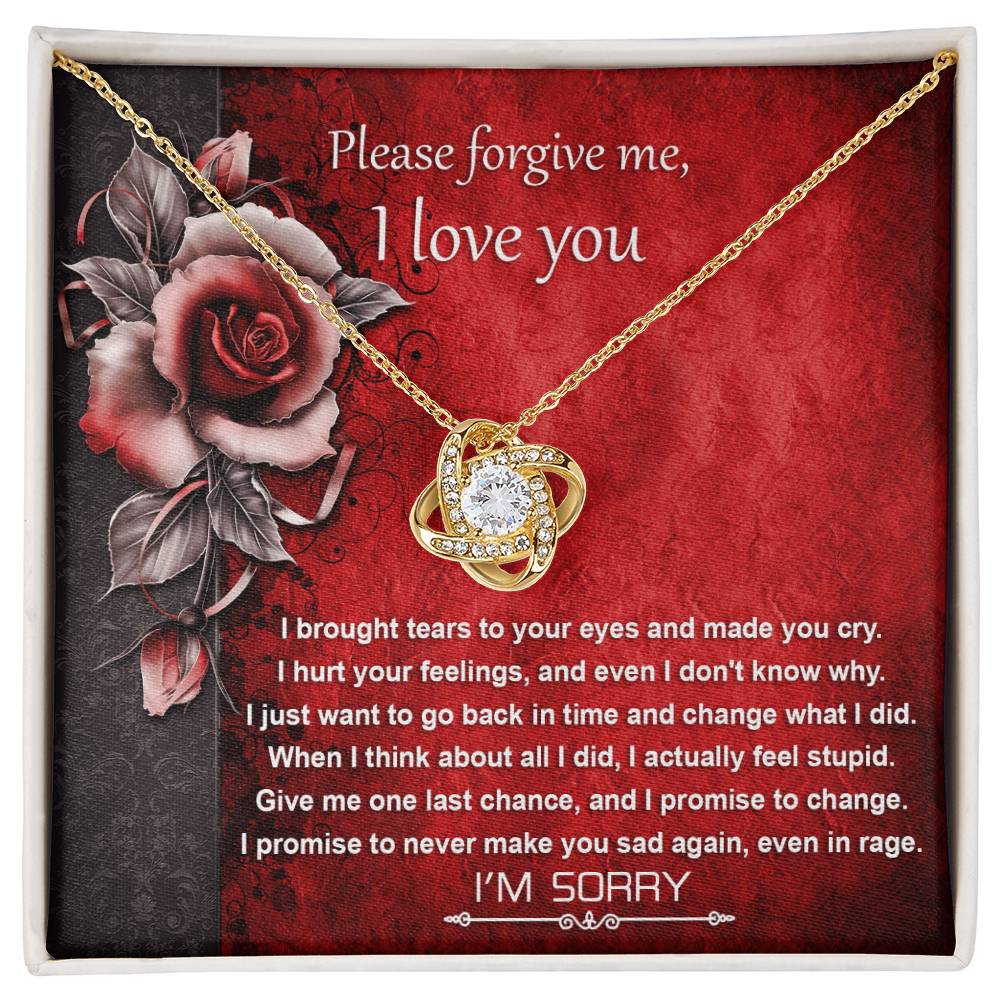 The "Sorry-One Last Chance - Love Knot Necklace" showcases an interlocking design and is elegantly displayed on a card featuring an apology message and images of red roses. Decorated with shimmering cubic zirconia crystals, this personalized gift is set against a red background with black floral accents.