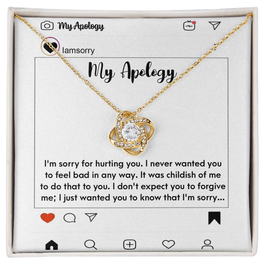 The "Sorry-My Apology - Love Knot Necklace," featuring a white gold finish and sparkling cubic zirconia crystals, is elegantly displayed in a box. The background includes an emotional apology message presented as a simulated social media post.