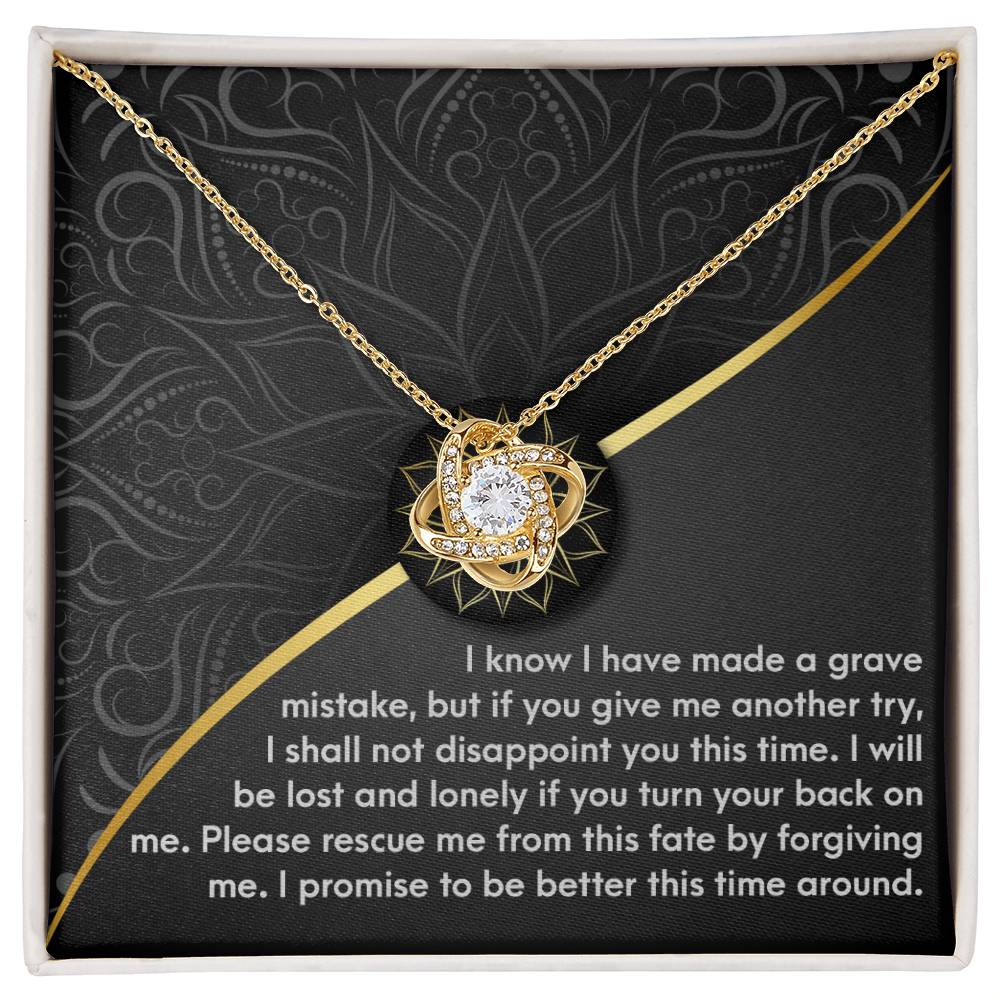 The "Sorry-Turn Your Back" Love Knot Necklace, featuring a crystal pendant, is elegantly displayed in a gift box. The background of the box showcases an ornate design and includes an apology message alongside a commitment to change.