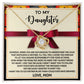 The Daughter-Further In Life - Love Knot Necklace, featuring a pendant with interlocking loops adorned with cubic zirconia crystals, is beautifully displayed over a heartfelt letter from a mother to her daughter, with a ribbon in the background.