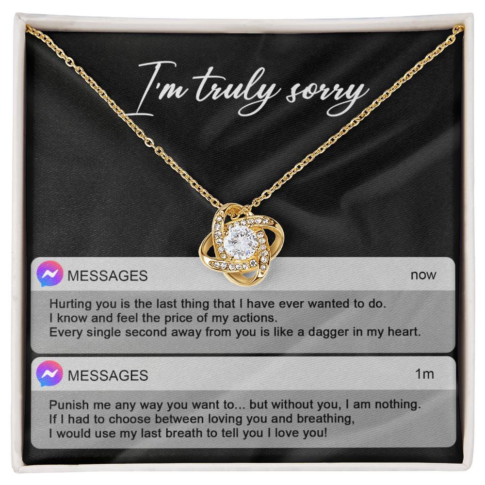 The Sorry-Away From You - Love Knot Necklace features interwoven heart pendants adorned with cubic zirconia crystals, and comes in a box with "I'm truly sorry" inscribed above. Accompanying the necklace are two text message excerpts expressing regret and love, making it an ideal personalized gift.