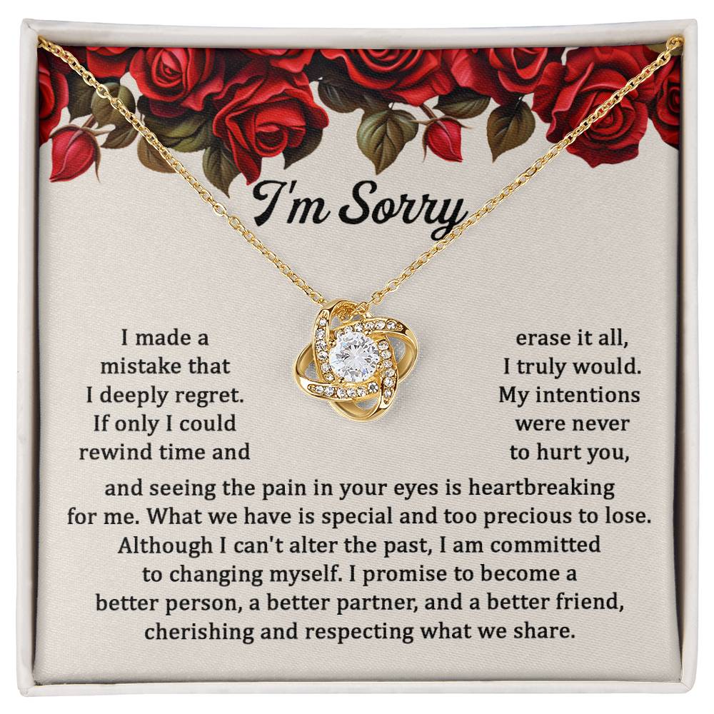 The "Sorry, Precious To Lose - Love Knot Necklace," adorned with cubic zirconia crystals, is displayed on a card featuring an apology message set against a background of red roses. The message expresses regret and a commitment to change.