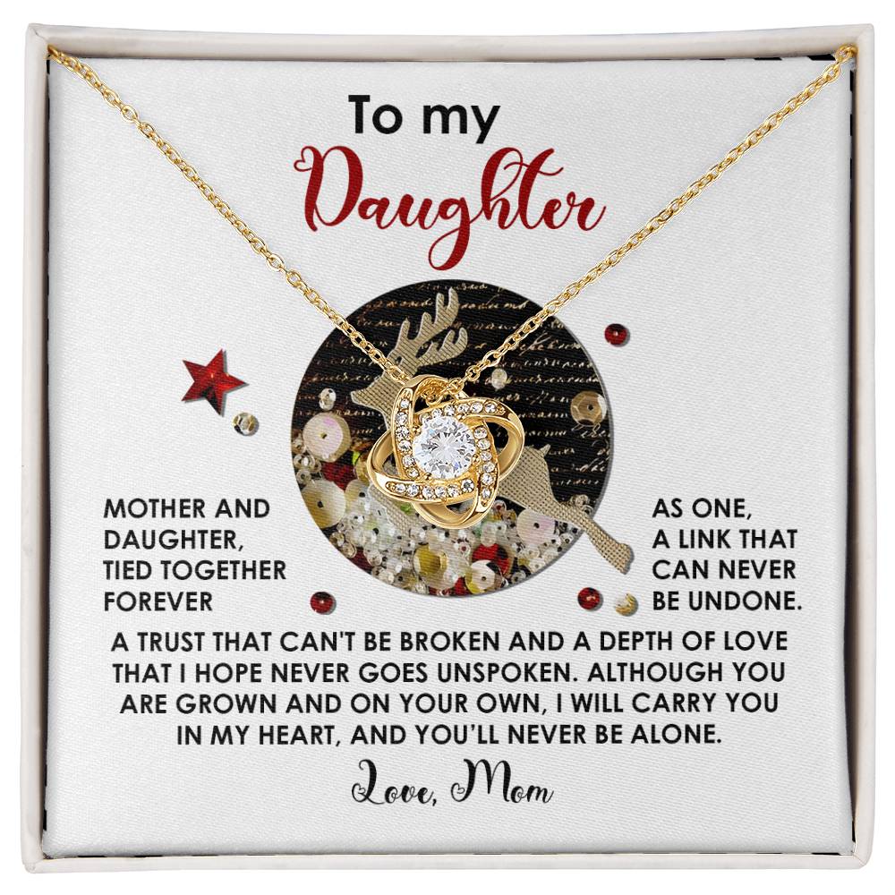 This distinctive gift, the Daughter-Forever As One - Love Knot Necklace adorned with shimmering cubic zirconia crystals, arrives in an elegantly crafted box. Inside, a heartfelt message proclaims: "To my Daughter," signed with unwavering love and support, "Love, Mom.