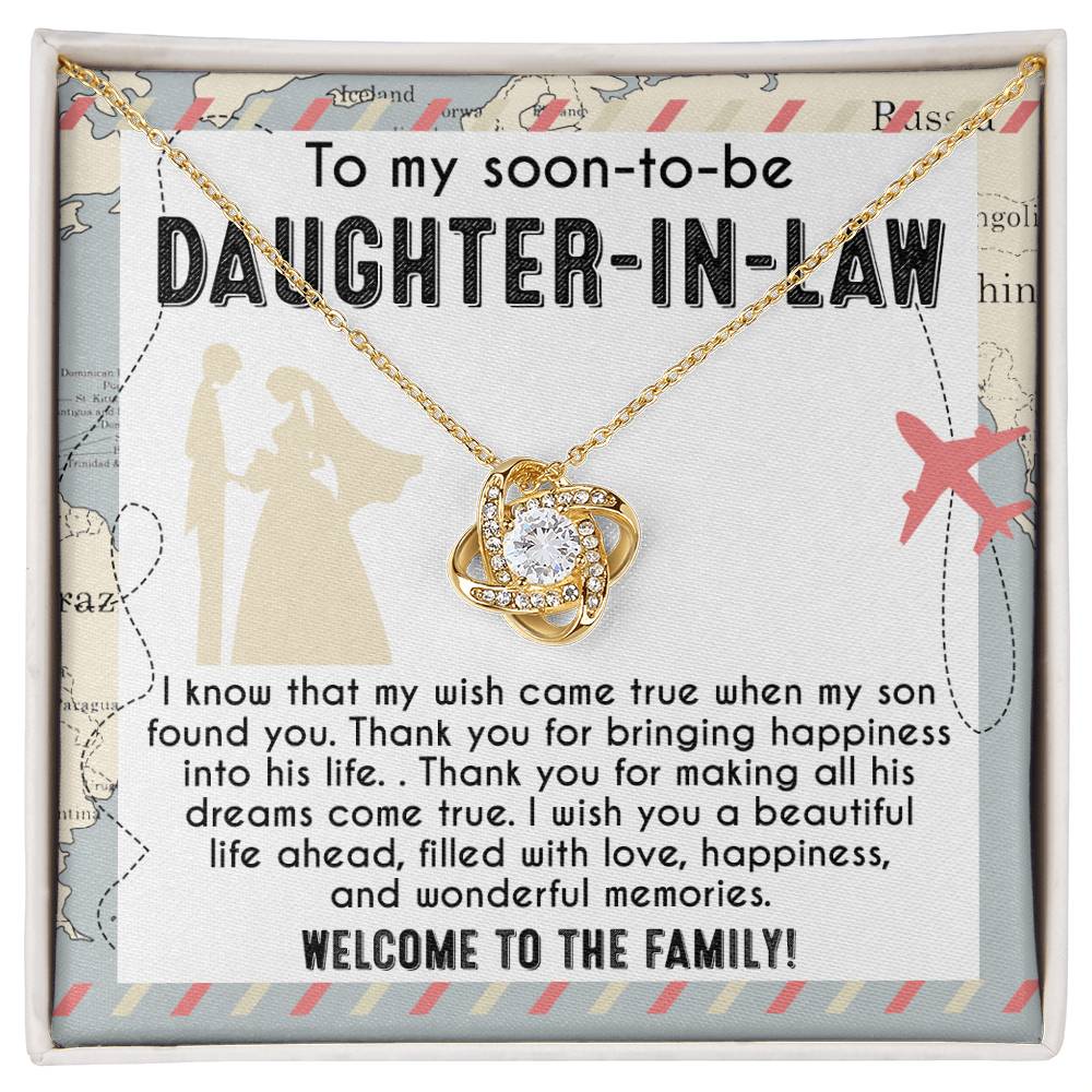 A To Daughter-in-Law, Into His Life - Love Knot Necklace with an intertwined design is displayed on a card that reads: "To my soon-to-be daughter-in-law. I wish you a beautiful life ahead, filled with love, happiness, and wonderful memories. Welcome to the family!" Available in white gold or yellow gold finish.