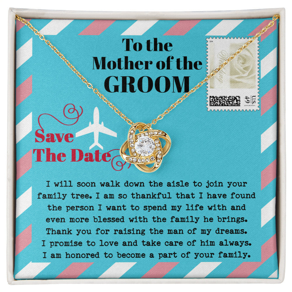 A silver *To Mom Of Groom, Down The Aisle - Love Knot Necklace* with a diamond knot pendant is displayed in a gift box. Adorned with cubic zirconia crystals, the necklace radiates elegance. The box has a message to the "Mother of the Groom" expressing gratitude and a commitment to caring for her son.