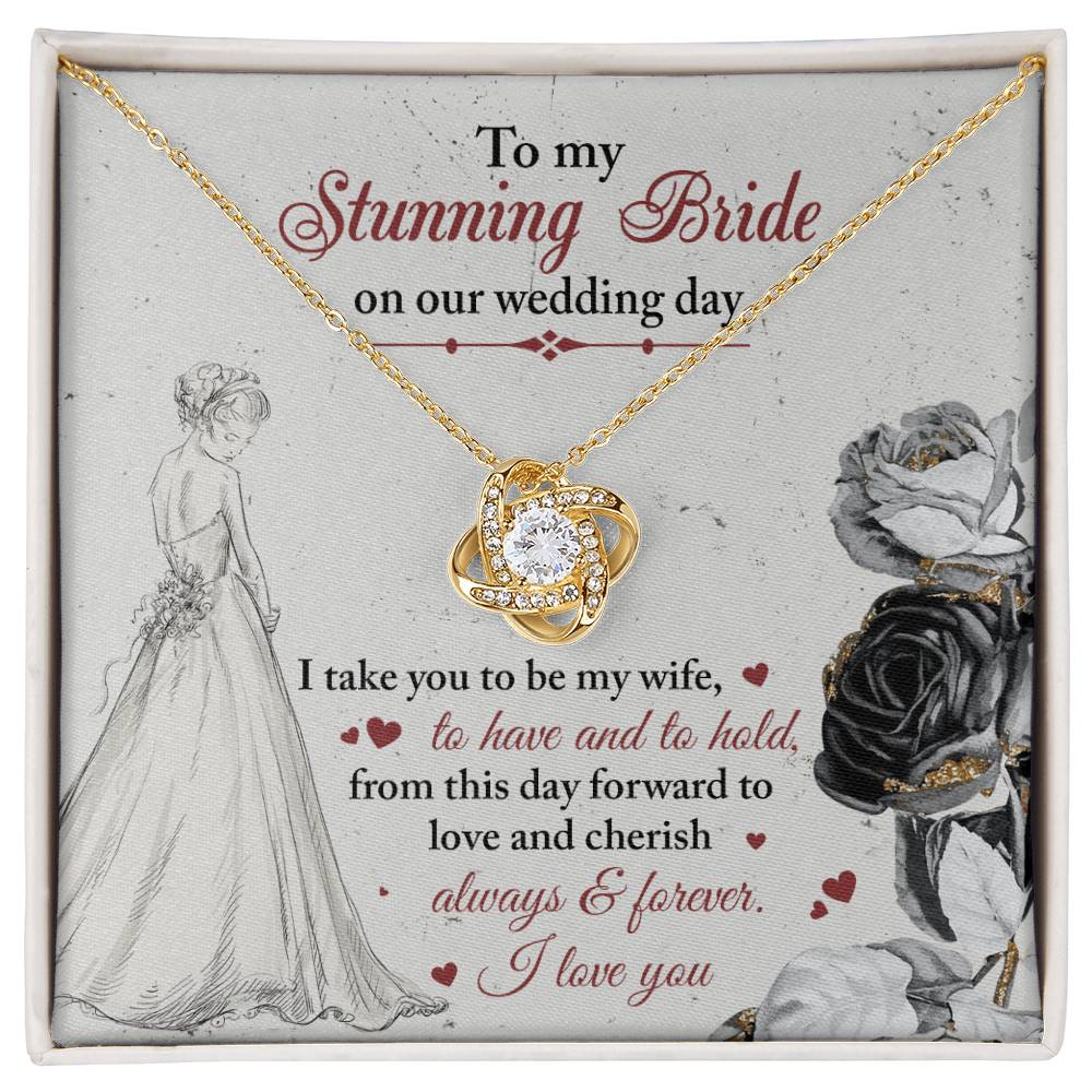 A To My Bride, Be My Wife - Love Knot Necklace with a pendant adorned in cubic zirconia crystals is displayed against a background featuring a bride illustration and a heartfelt wedding message.