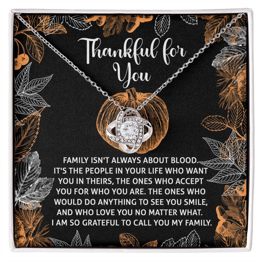 The Thanksgiving-To Call You - Love Knot Necklace comes with a pendant on a decorative card that reads "Thankful for You." It features an inspiring message about the significance of chosen family and love. The necklace shines with a white gold finish and is adorned with sparkling cubic zirconia, beautifully capturing your heartfelt sentiments.