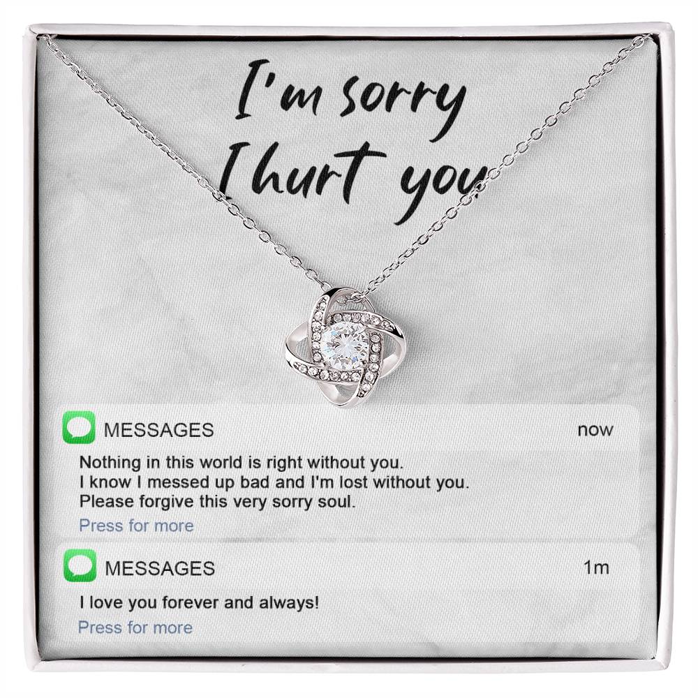 Image of the Sorry-Lost Without You - Love Knot Necklace with a diamond pendant against a background with the text "I'm sorry I hurt you." Below are text messages reading "Nothing in this world is right without you... Please forgive this very sorry soul." and "I love you forever and always!