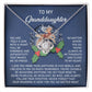 The Granddaughter-Here For You - Love Knot Necklace is elegantly showcased in a box, accompanied by a heartfelt message for a granddaughter. It features a beautiful reindeer and holly design, crafted in 14k White Gold with shimmering Cubic Zirconia accents that add sparkle to its timeless charm.