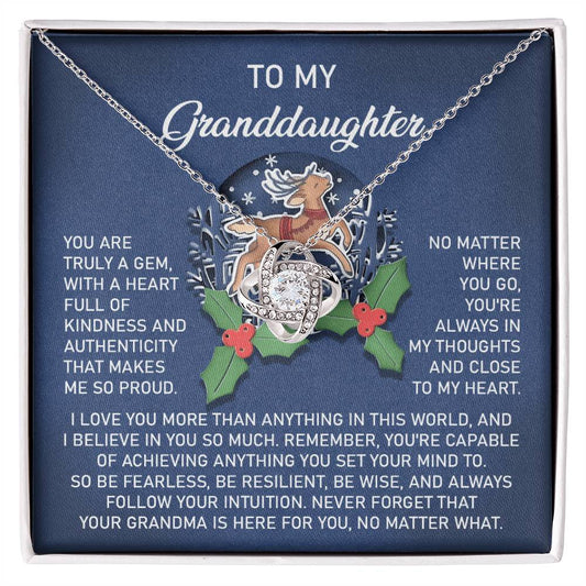 The Granddaughter-Here For You - Love Knot Necklace is elegantly showcased in a box, accompanied by a heartfelt message for a granddaughter. It features a beautiful reindeer and holly design, crafted in 14k White Gold with shimmering Cubic Zirconia accents that add sparkle to its timeless charm.