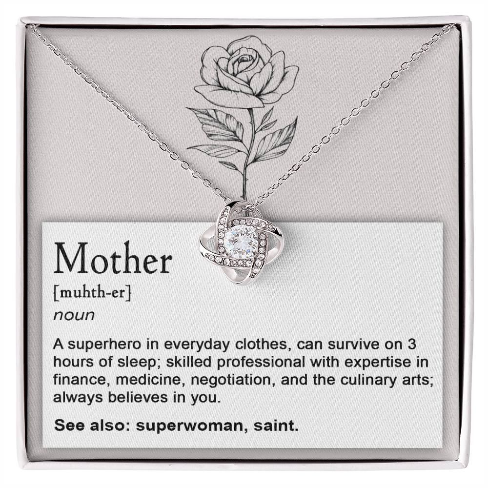 A box containing the "To Mom, Superhero - Love Knot Necklace" showcases a knot design adorned with cubic zirconia crystals. The background text includes the definition of "Mother" and extols her various skills, comparing her to a superwoman and saint. A rose illustration is positioned above.