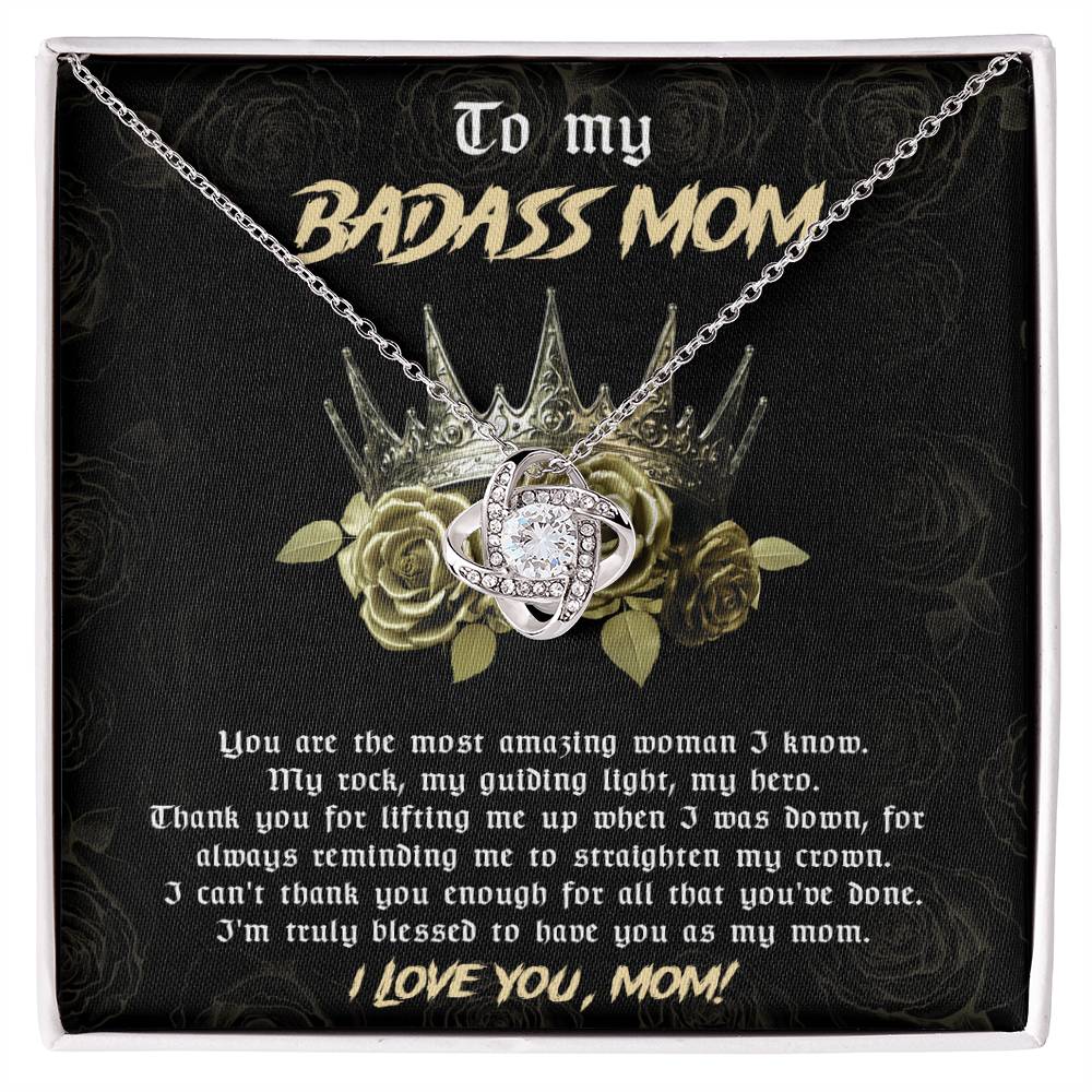 To Mom, Straighten My Crown - Love Knot Necklace featuring a silver and diamond pendant on a card that reads: "To my Badass Mom. You are the most amazing woman I know. ... I'm truly blessed to have you as my mom. I love you, Mom!" This personalized gift is beautifully adorned with shimmering cubic zirconia crystals, making it the perfect way to show your love and appreciation.