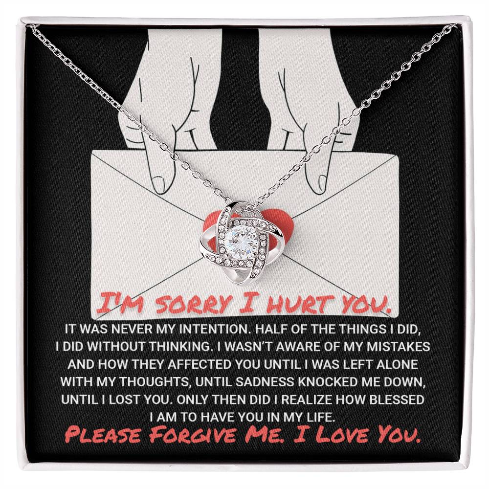 The "Sorry-Without Thinking - Love Knot Necklace" features a 14k White Gold pendant on a card that reads: "I'm sorry I hurt you. Please Forgive Me. I Love You." This heartfelt message is beautifully complemented by Cubic Zirconia Crystals, making it a truly special and meaningful gift.