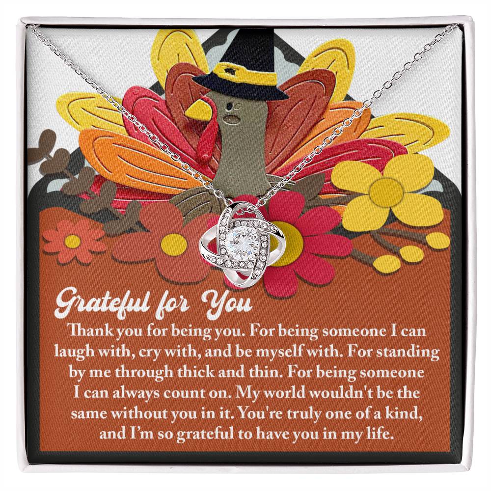 The Thanksgiving-Being You - Love Knot Necklace features intertwined loops embellished with sparkling cubic zirconia crystals. It is presented on a card adorned with a turkey and autumn flowers, expressing gratitude and appreciation for someone special. This personalized gift is ideal for showcasing your heartfelt sentiments.