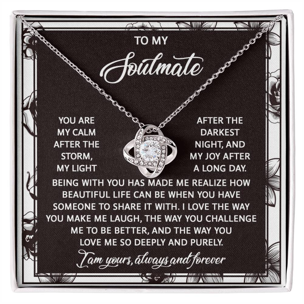 The Soulmate-Deeply And Purely Love Knot Necklace is a personalized gift showcasing an intertwined design with a silver heart. It features cubic zirconia crystals and comes on a printed card with a touching message about love and companionship.