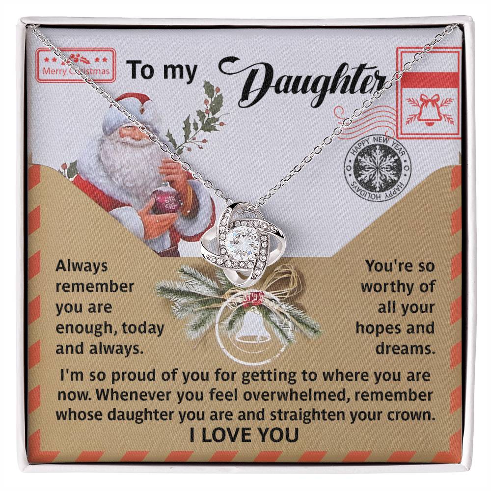 The Daughter-All Your Hopes - Love Knot Necklace showcases intertwined cubic zirconia crystals, beautifully presented on a card with Christmas-themed graphics and heartfelt messages, providing love and encouragement for a daughter.