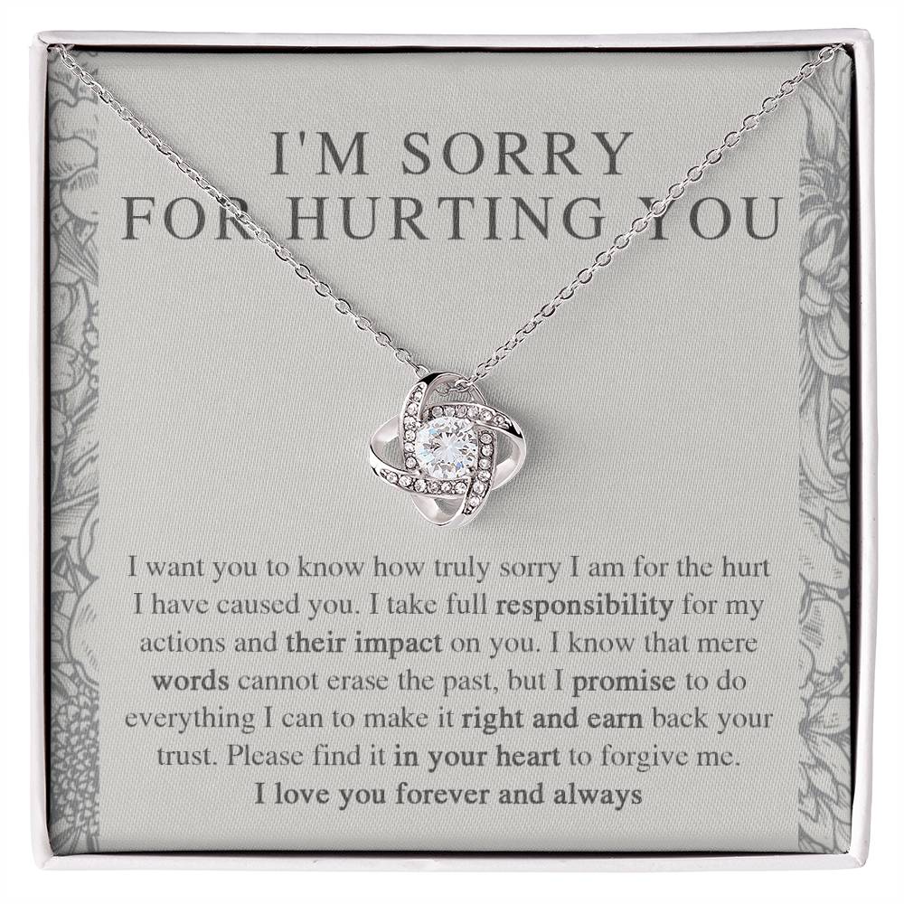 The Sorry-Do Everything - Love Knot Necklace features an eye-catching silver intertwined pendant, elegantly adorned with cubic zirconia crystals, showcased against a heartfelt printed apology message. The message conveys sincere regret, taking responsibility, and earnestly asking for forgiveness with love.