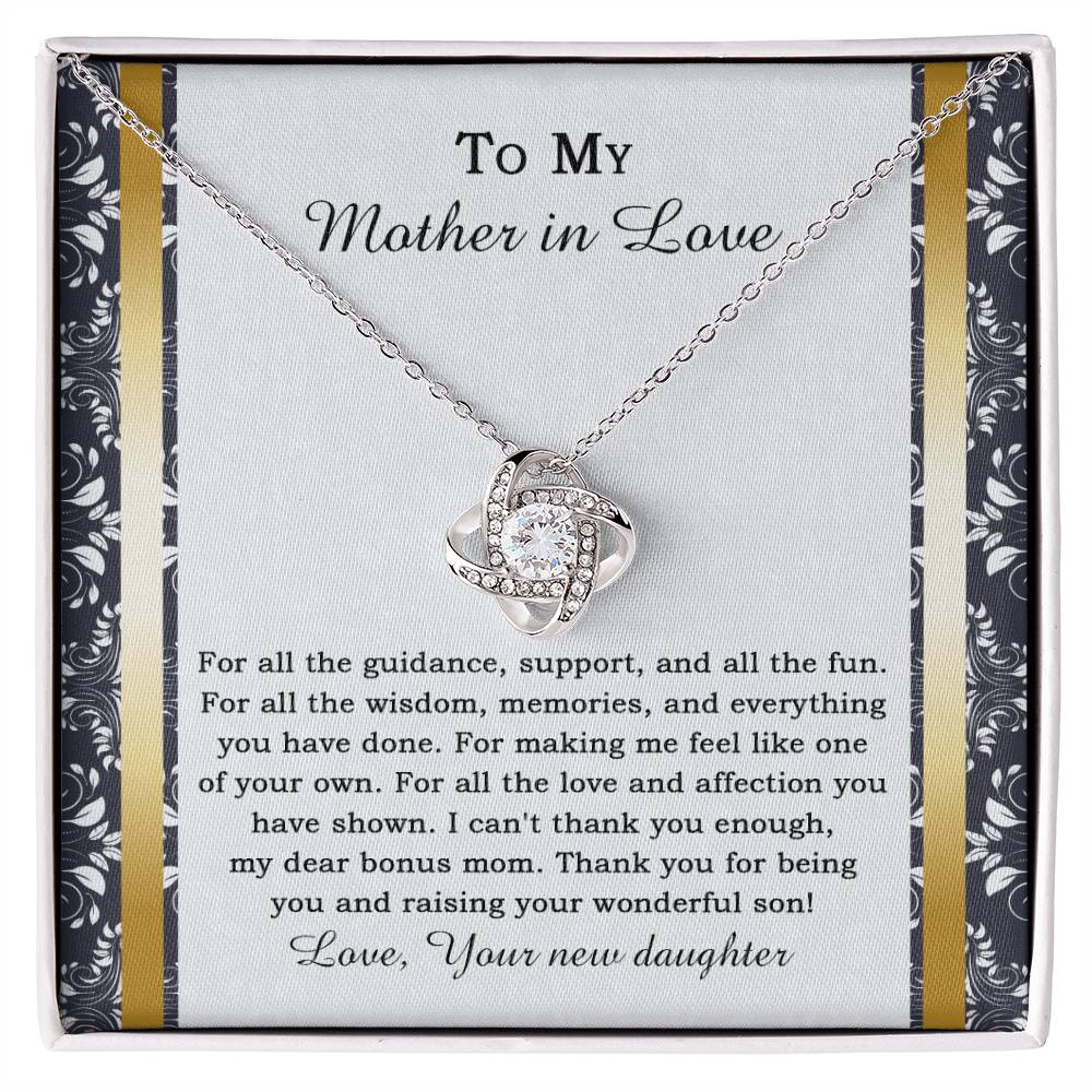 The "To Mother-in-law, Of Your Own - Love Knot Necklace" features a heart-shaped pendant adorned with cubic zirconia crystals, and it comes on a card expressing gratitude for a mother-in-law's love and support.