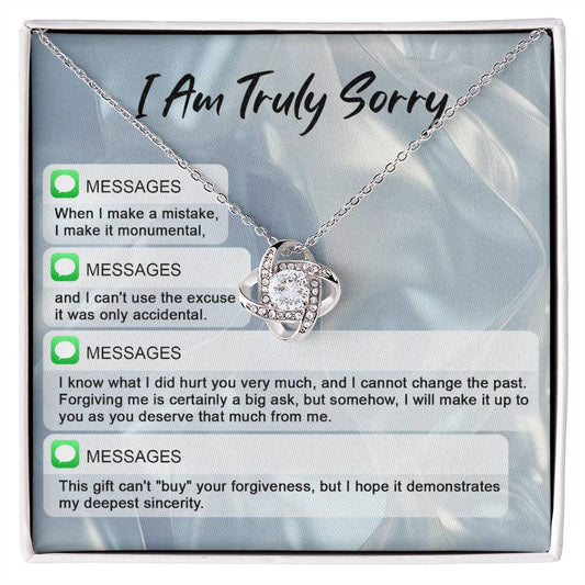 The "Sorry, Make A Mistake - Love Knot Necklace" adorned with cubic zirconia crystals, placed over a background card that reads "I Am Truly Sorry" and includes a series of apology text messages, is the perfect personalized gift for heartfelt apologies.