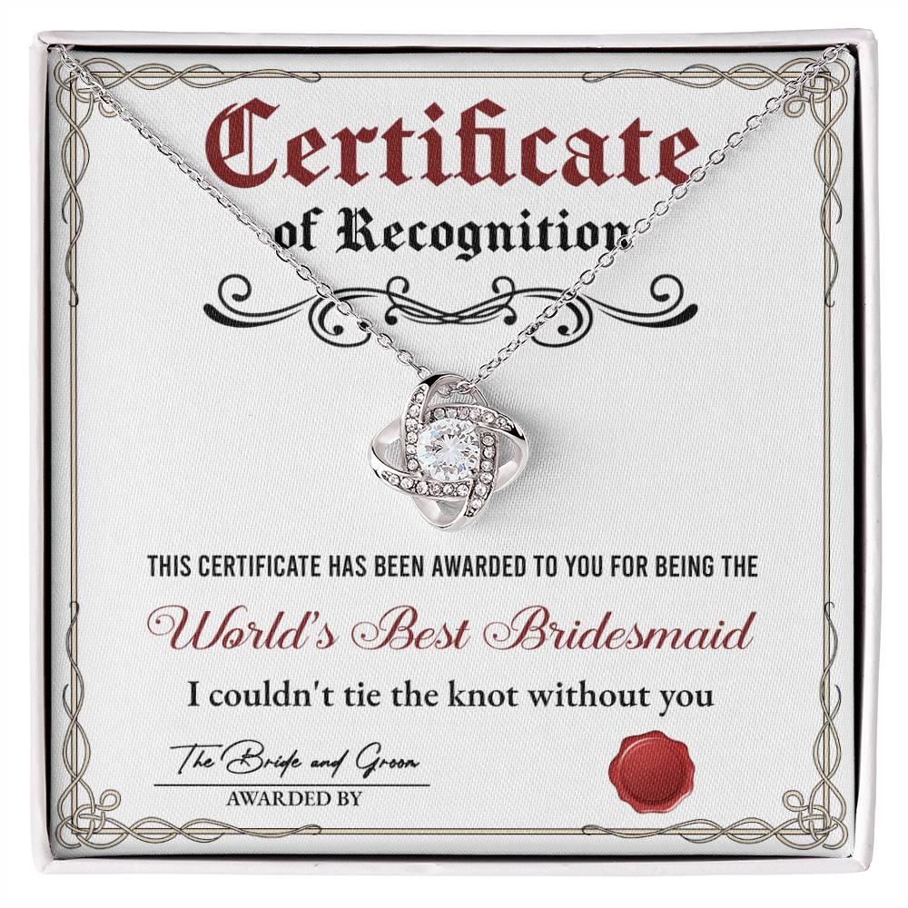 A stunning To Bridesmaid, Certificate Of Recognition - Love Knot Necklace in 14k white gold, adorned with cubic zirconia crystals, is displayed on a certificate that reads "World's Best Bridesmaid" awarded by the bride and groom.