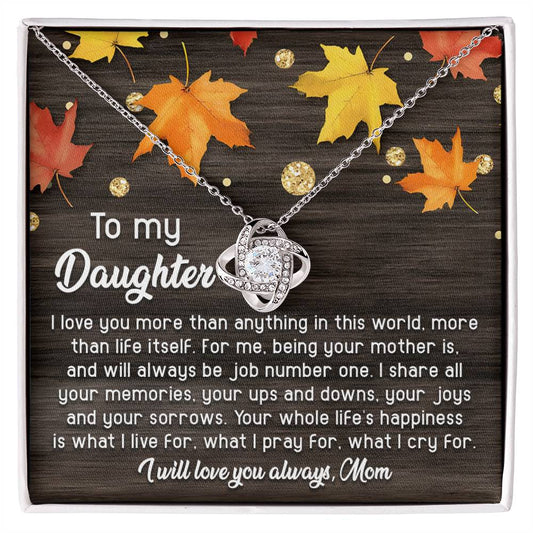 The Daughter-Job Number One - Love Knot Necklace features a heart-shaped pendant adorned with cubic zirconia crystals, beautifully displayed on a card that reads: "To my Daughter, I love you more than anything, more than life itself. I will love you always, Mom." This elegant piece is available in either a white gold or yellow gold finish.