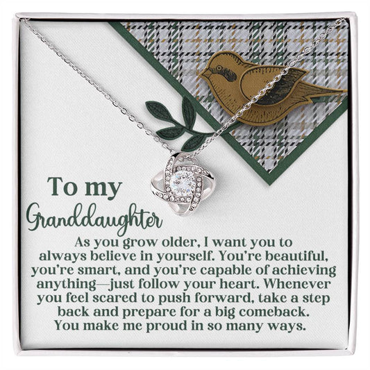 Introducing the "Granddaughter-A Big Comeback - Love Knot Necklace," which features an interlocking design beautifully adorned with Cubic Zirconia Crystals. It rests on a card showcasing a charming bird and leaf motif, accompanied by a heartfelt message for your granddaughter. Available in a choice of White Gold or Yellow Gold Finish, it elegantly symbolizes unbreakable bonds.