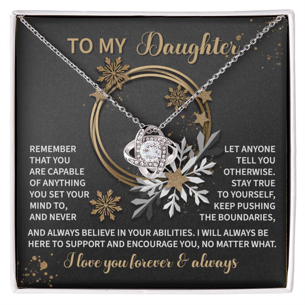 The Daughter-Set Your Mind - Love Knot Necklace comes on a display card with an inspirational message about self-belief and authenticity. Featuring elegant gold and silver designs, this necklace includes a sparkling cubic zirconia pendant, making it an exceptionally personalized gift.