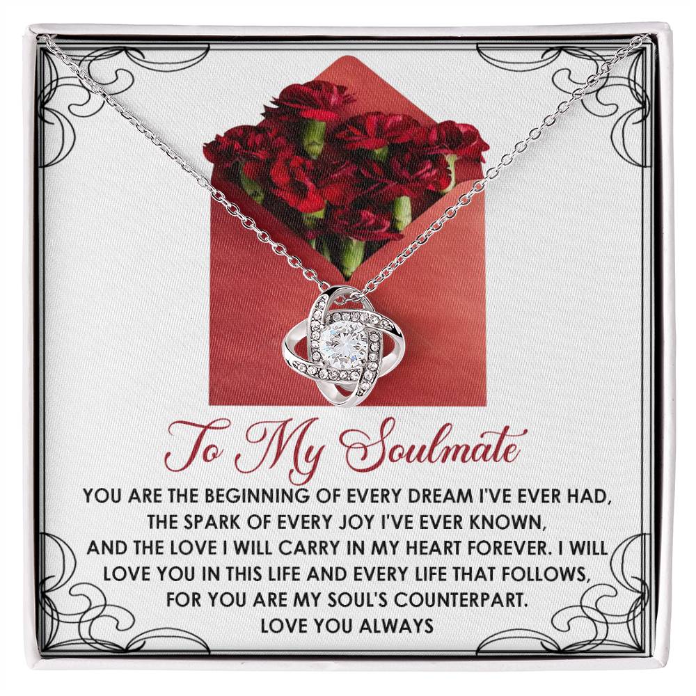 The Soulmate-My Heart Forever Love Knot Necklace is showcased on a card with red flowers and a touching "To My Soulmate" message, featuring shimmering cubic zirconia.