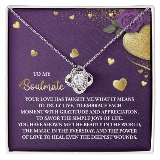 The Soulmate-Joys Of Life Love Knot Necklace features interlocking rings on a purple background with gold heart accents and cubic zirconia crystals, crafting a beautiful testament to love and soulmates. It's the perfect personalized gift for that special someone.
