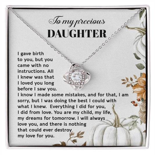 A Daughter-Did From Love - Love Knot Necklace features a heart-shaped pendant adorned with cubic zirconia crystals and comes in a gift box. The box includes a note titled "To my precious DAUGHTER" with a heartfelt message about a mother's love for her child, making it the perfect personalized gift.