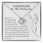 A To Mom, Wedding My Wedding Day - Love Knot Necklace with a card that reads: "To my beautiful mom on my wedding day" with a sentimental message about a daughter's gratitude towards her mother, featuring an illustration of a bride and her mother. The necklace is made of 14k white gold and adorned with cubic zirconia crystals.