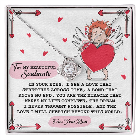 The Soulmate-No End Love Knot Necklace features a heart-shaped pendant with cubic zirconia on a card with a cherub holding a heart. It's accompanied by love and soulmate text, creating the perfect gift for someone special.