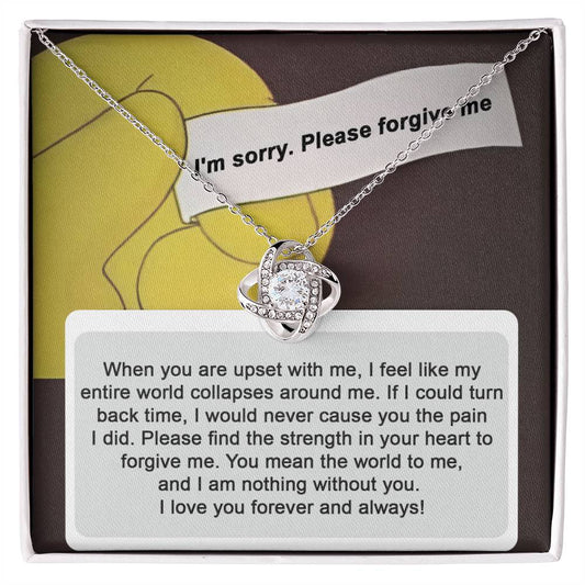 A "Sorry, Nothing Without You" Love Knot Necklace adorned with cubic zirconia crystals is elegantly placed over a card that reads, "When you are upset with me..." and continues with a heartfelt apology and expression of love.