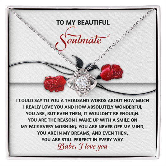 The Soulmate-Every Morning Love Knot Necklace features a rose design with cubic zirconia crystals. It comes in an elegant box and includes the message: "To my beautiful soulmate," ending with "Babe, I love you." A truly personalized gift for that special someone.