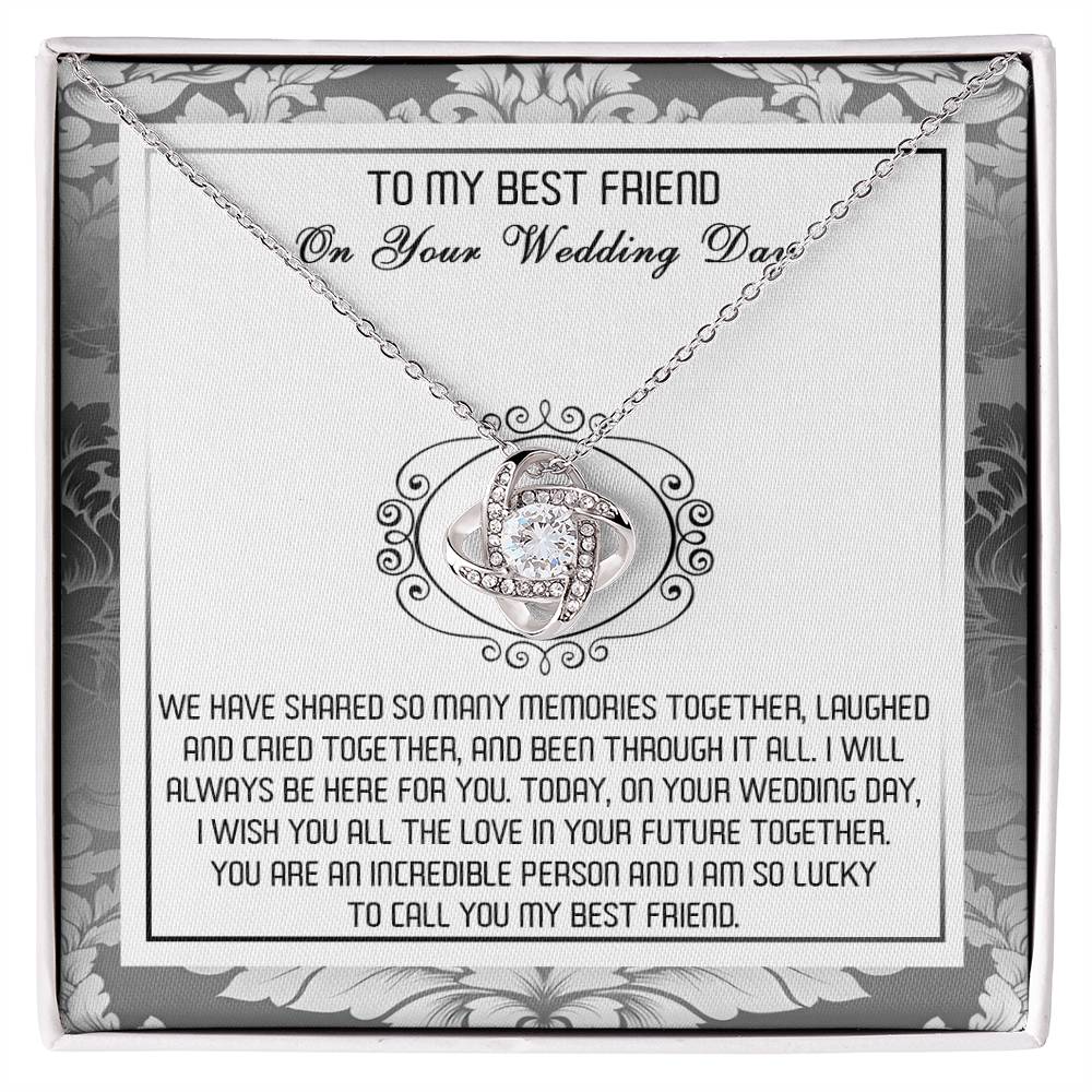 A decorative box containing the "To Best Friend, An Incredible Person - Love Knot Necklace," crafted in 14k white gold with an intricate pendant adorned with cubic zirconia crystals and a heartfelt message titled "To My Best Friend On Your Wedding Day.