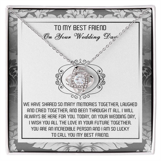 A decorative box containing the "To Best Friend, An Incredible Person - Love Knot Necklace," crafted in 14k white gold with an intricate pendant adorned with cubic zirconia crystals and a heartfelt message titled "To My Best Friend On Your Wedding Day.