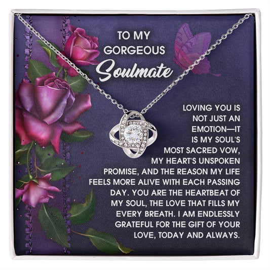 The Soulmate-Unspoken Promise - Love Knot Necklace showcases a silver intertwined pendant with cubic zirconia, set on a card with purple roses and a heartfelt love message, creating an ideal personalized gift for your soulmate.