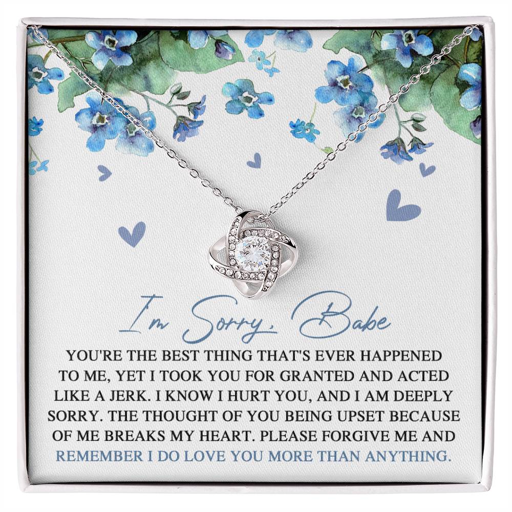 Introducing the "Sorry-More Than Anything - Love Knot Necklace," featuring a cubic zirconia pendant set against a floral background. This heartfelt personalized gift comes with a note that reads, "I'm Sorry, Babe. You're the best thing that's ever happened to me... Please forgive me and remember I do love you more than anything.