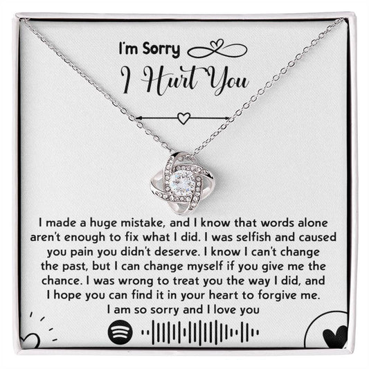 The "Sorry-You Didn't Deserve - Love Knot Necklace" features an intertwined heart pendant adorned with cubic zirconia crystals and a gold finish, beautifully presented in a box with a heartfelt apology message. The message conveys deep regret, asks for forgiveness, and promises to change.