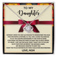 The Daughter-Further In Life Love Knot Necklace, featuring intertwined hearts, is beautifully presented on a note from a mother to her daughter. It conveys love, guidance, and aspirations for her daughter’s success. Available in either white gold or yellow gold finishes with sparkling cubic zirconia crystals, this necklace accentuates the heartfelt message signed "Love, Mom.