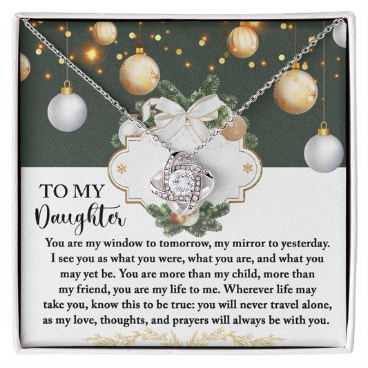 The Daughter-My Mirror - Love Knot Necklace, crafted in silver and embellished with cubic zirconia crystals, is beautifully presented in a box. The backdrop includes holiday decorations and a touching message for a daughter, making it an ideal personalized gift.