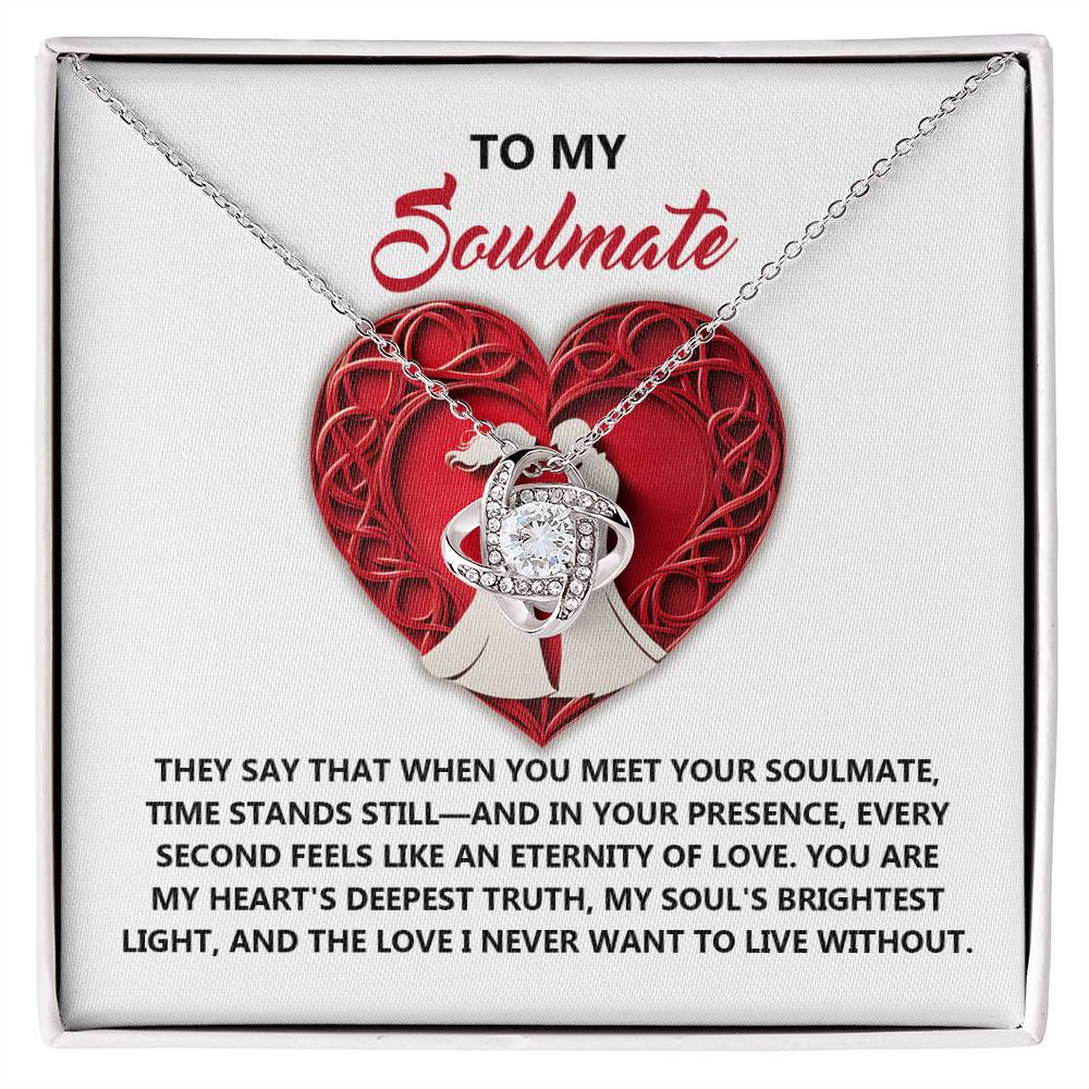 The Soulmate-Deepest Truth Love Knot Necklace features a heart-shaped pendant with interlocking rings on a card that reads "To My Soulmate" and has a touching message about love. Adorned with shimmering cubic zirconia, it's an ideal personalized gift for any cherished occasion.