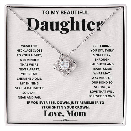 To My Beautiful Daughter, Wear This Necklace - Love Knot Necklace shaped pendant necklace with encrusted jewels on a card with a sentimental message from a mother to her daughter.