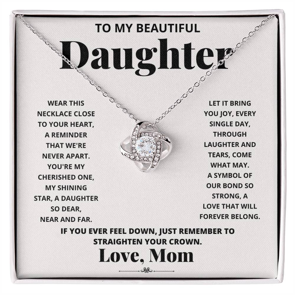 To My Beautiful Daughter, Wear This Necklace - Love Knot Necklace shaped pendant necklace with encrusted jewels on a card with a sentimental message from a mother to her daughter.