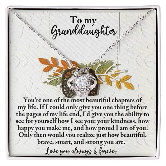 The Granddaughter-How Beautiful - Love Knot Necklace, crafted in white gold with an interwoven heart design, is presented on a card featuring a heartfelt message for your granddaughter.